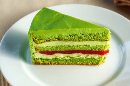 Photo for Emerald Euphoria: A Sumptuous Slice of Verdant Green Cake on Delicate White Porcelain - Royalty Free Image