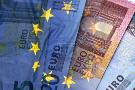 Foto de European union currency and flag of EU on surface, business concept picture - Imagen libre de derechos