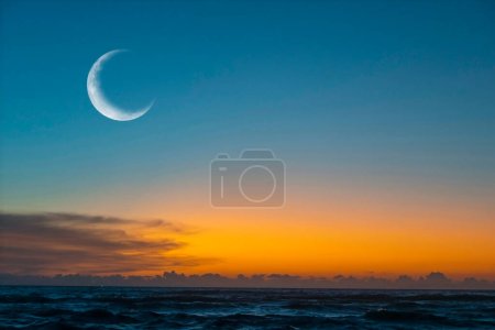 New moon or rescent above ocean.