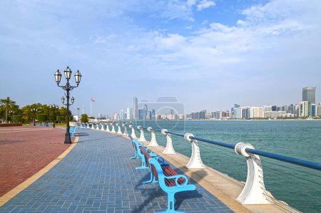Waterfront view of Abu Dhabi with sea, skyscrapers from Corniche embankment	