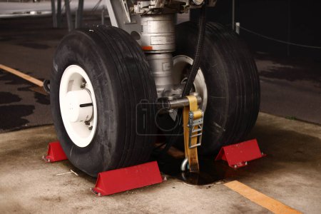 Brake on the landing gear of the aircraft. A double-decker plane for many passengers. Standing in the parking lot