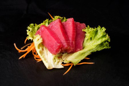 Photo for Salmon fillet on a leaf of green salad - Royalty Free Image