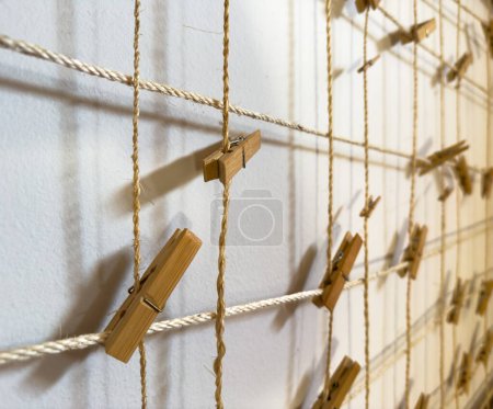 Photo for Wooden pegs clipped to string with nothing attached - Royalty Free Image