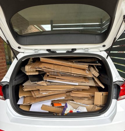 Photo for Concept of a trunk full of stacked cardboard to be taken to recycling depot - Royalty Free Image