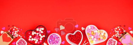 Photo pour Valentines Day candy bottom border with assorted sweets. Top view on a red paper background with copy space. - image libre de droit