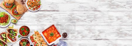 Photo for Healthy plant based vegetarian meal corner border. Top view on a white wood banner background. Jackfruit tacos, zucchini lasagna, walnut bolognese zoodles, chickpea burgers, hummus, soups, salad. - Royalty Free Image