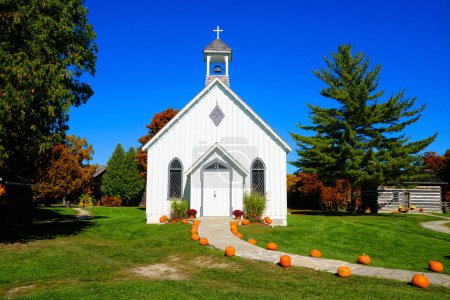 Ontario autumn countryside scene with old wooden chapel and pumpkin lined walk, Balls Falls Conservation Area, Niagara region, Canada
