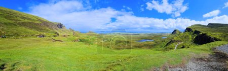 Isle of Skye, Scotland. Panoramic view over the green mountain highland landscape of the Quiraing.
