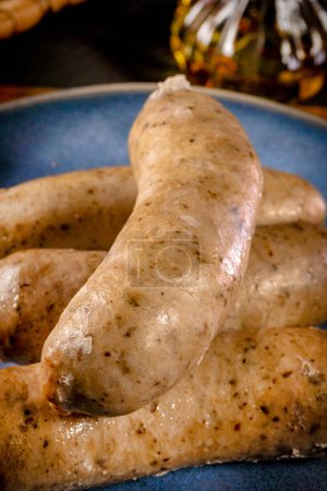 Boiled white sausage on a plate. Selective focus.