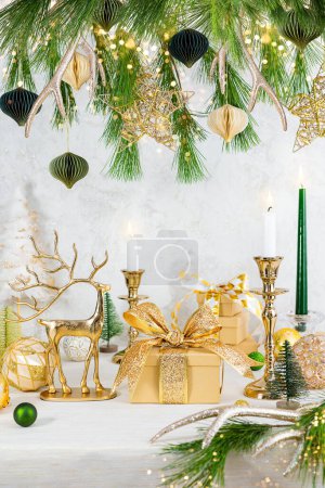 Photo for Christmas or New Year festive composition. Christmas tree and balls, candles, stars, gift boxes. - Royalty Free Image