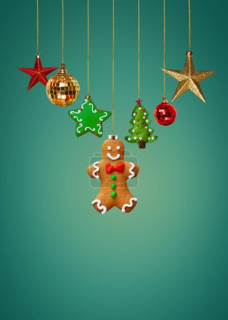 Photo for Christmas homemade gingerbread cookies and Christmas decorations on teal background - Royalty Free Image