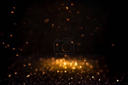 Photo for Warm golden bokeh lights illuminate a dark backdrop, creating an abstract pattern of soft glowing orbs ideal for backgrounds. Blurred shine bokeh for overlay effect. - Royalty Free Image