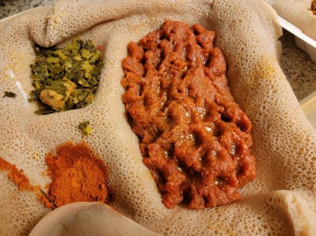 Photo for Ethiopian food savory and delicious kitfo raw beef with injera bread - Royalty Free Image