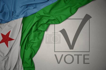 Foto de Ondeando colorida bandera nacional de djibouti sobre un fondo gris con voto de texto. concepto de elección. Ilustración 3D - Imagen libre de derechos