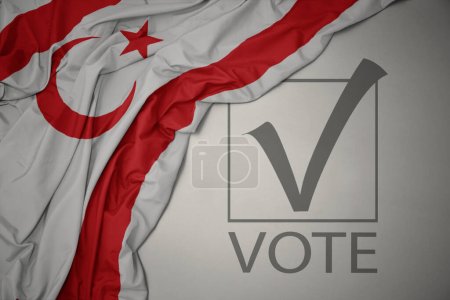 waving colorful national flag of northern cyprus on a gray background with text vote. election concept. 3D illustration