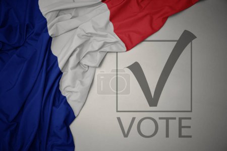 Foto de Ondeando colorida bandera nacional de Francia sobre un fondo gris con voto de texto. concepto de elección. Ilustración 3D - Imagen libre de derechos
