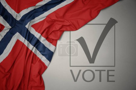Foto de Ondeando colorida bandera nacional de Noruega sobre un fondo gris con voto de texto. concepto de elección. Ilustración 3D - Imagen libre de derechos