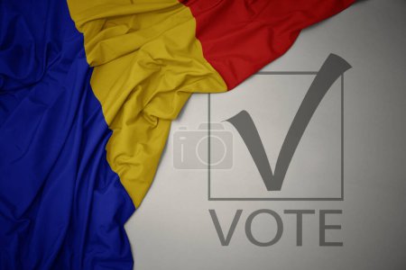 Foto de Ondeando colorida bandera nacional de romania sobre un fondo gris con voto de texto. concepto de elección. Ilustración 3D - Imagen libre de derechos