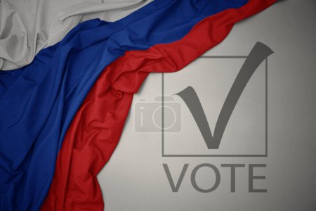 Foto de Ondeando colorida bandera nacional de Rusia sobre un fondo gris con voto de texto. concepto de elección. Ilustración 3D - Imagen libre de derechos