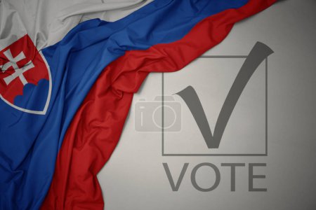 Foto de Ondeando colorida bandera nacional de Eslovaquia sobre un fondo gris con voto de texto. concepto de elección. Ilustración 3D - Imagen libre de derechos