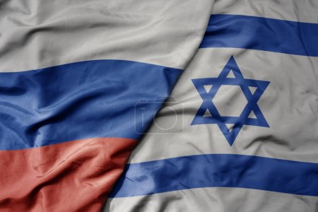 big waving realistic national colorful flag of russia and national flag of israel . macro
