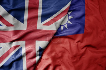 big waving national colorful flag of great britain and national flag of taiwan . macro