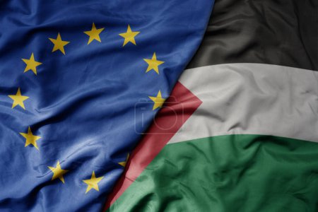 Foto de Gran ondeando bandera colorida nacional realista de la unión europea y bandera nacional de palestina. macro - Imagen libre de derechos