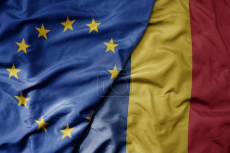 Foto de Gran ondeando bandera colorida nacional realista de la unión europea y bandera nacional de romania. macro - Imagen libre de derechos