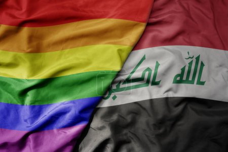 grand drapeau coloré national réaliste agitant iraq et drapeau arc-en-ciel gay pride. macro