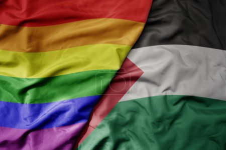 Foto de Gran ondeando bandera colorida nacional realista de palestina y arco iris bandera orgullo gay. macro - Imagen libre de derechos