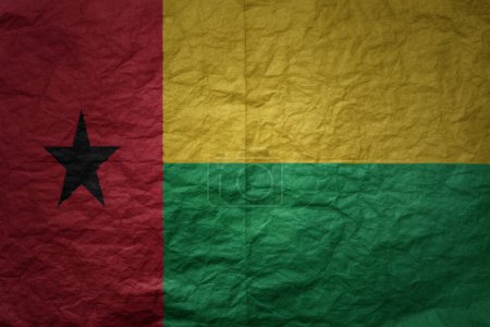 Photo for Colorful big national flag of guinea bissau on a grunge old paper texture background - Royalty Free Image