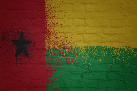 Photo for Colorful painted big national flag of guinea bissau on a massive old brick wall - Royalty Free Image