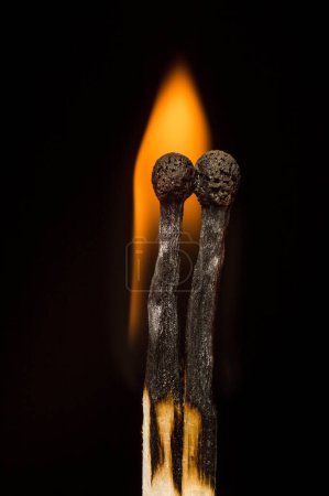 two matches on a black background