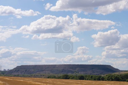 Photo for Against the background of the field rock dump - Royalty Free Image