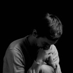 black and white dramatic photo in a depressed pose
