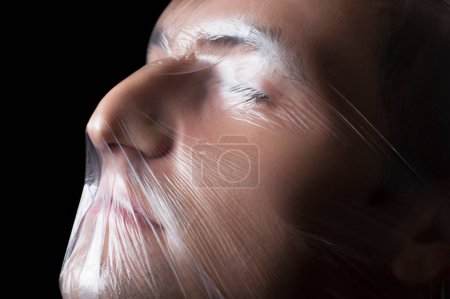 Photo for Close-up portrait of a plastic bag on the face asphyxiation - Royalty Free Image