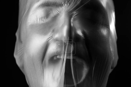 Photo for Close-up portrait of a plastic bag on the face asphyxiation - Royalty Free Image