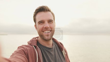 Photo for Young laughing man taking selfi - Royalty Free Image