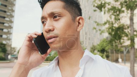 Photo for Portrait of young businessman talking on smartphone - Royalty Free Image