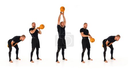 Téléchargez les photos : A kettlebell trainer demonstrating the American kettlebell swing with a yellow kettlebell isolated on a white background - en image libre de droit