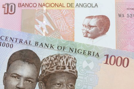 Photo for A macro image of a blue, purple and green one thousand  naira note from Nigeria paired up with a colorful ten kwanza bank note from Angola.  Shot close up in macro. - Royalty Free Image