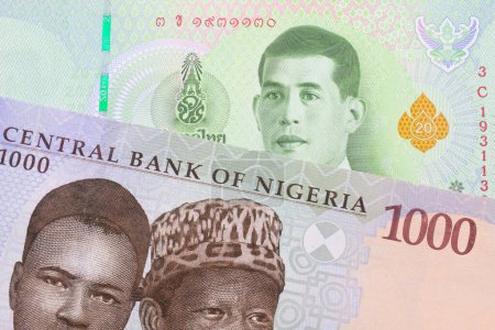 Foto de Una imagen macro de un billete de mil nairas azul, púrpura y verde de Nigeria emparejado con un billete de banco verde de veinte baht de Tailandia. Disparo de cerca en macro. - Imagen libre de derechos
