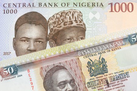 Photo for A macro image of a blue, purple and green one thousand  naira note from Nigeria paired up with a colorful fifty shilling bank note from Kenya.  Shot close up in macro. - Royalty Free Image