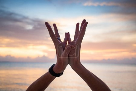 Photo for Hand in lotus mudra at sunset - Royalty Free Image