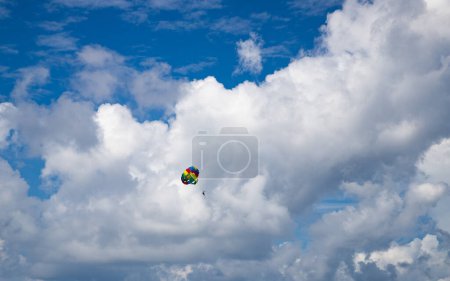 Photo for Parasailing against blue sky rainbow colors - Royalty Free Image