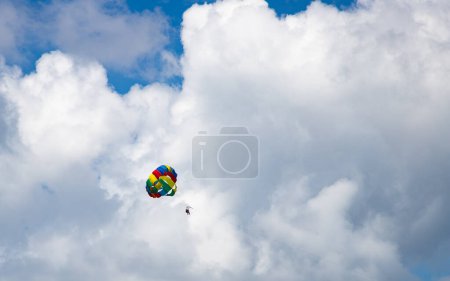 Photo for Parasailing against blue sky rainbow colors - Royalty Free Image