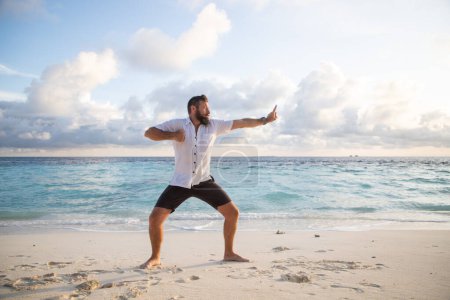 Foto de Hombre practicando qigong junto al mar - Imagen libre de derechos