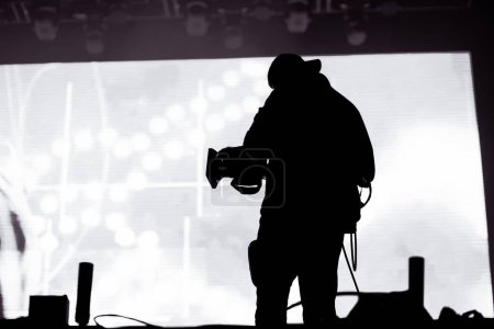 Photo for Cameraman silhouette in stage lights - Royalty Free Image
