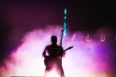 Photo for Guitarist silhouette in stage lights - Royalty Free Image