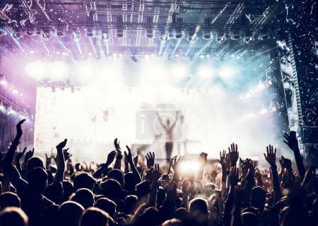 Foto de Crowd partying stage lights live concert summer music festival - Imagen libre de derechos